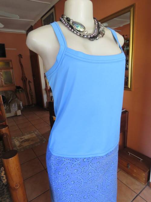 Skyblue strappy cami in 100% stretch polyester by 'IN CHARGE' in 36/12.As new.