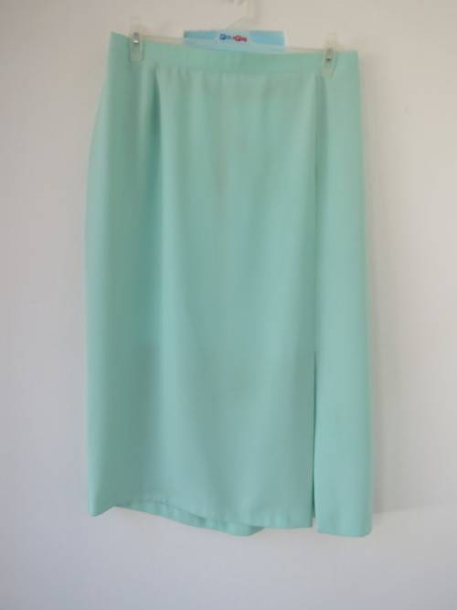 Elegant,light turquoise pencil skirt with slit on left front.By 'DONNA CLAIRE' in size 44/20.As new