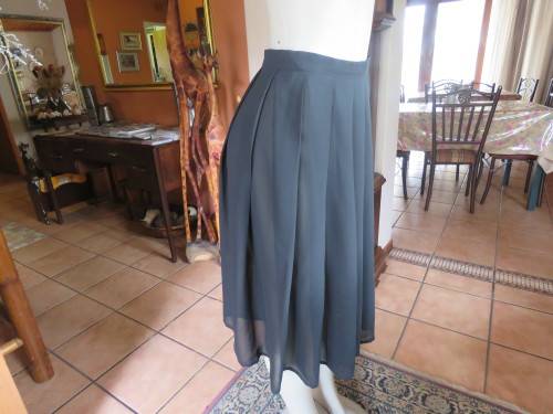 Black sheer polyester knife pleated skirt.Made by 'PRINCESS' in size 32//8.In good condition.
