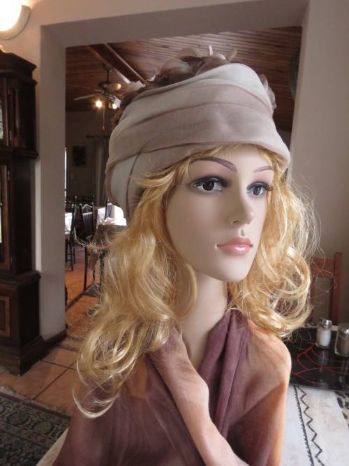 Ladies special occasion hat in different beige/brown colours.In folded organza with flowers.