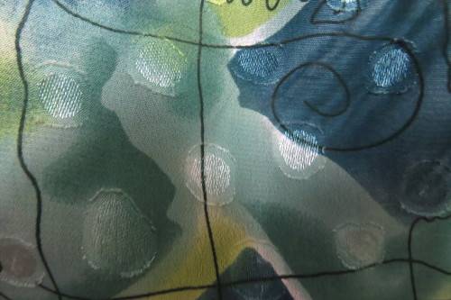 Cheerful summer blouse in medley of greens with black curled lines. Size 44/20.