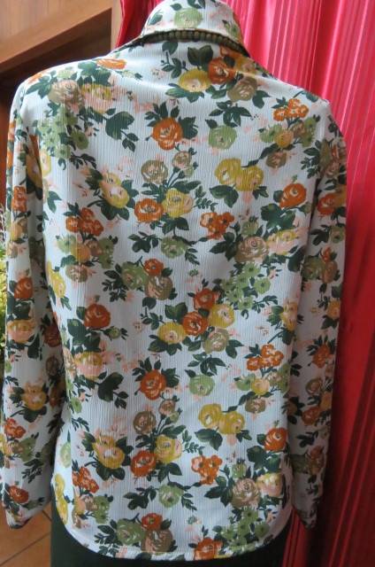 Boutique made long sleeve top size 36/12. Button down front with covered buttons and open collar.
