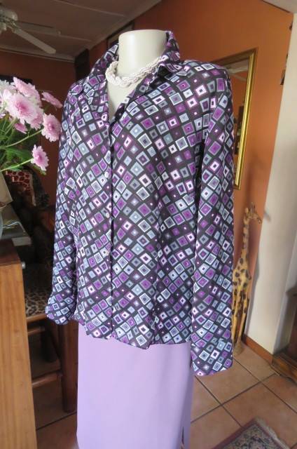 Elegant long sleeve top in black with off line purple, white and grey square blocks. Size 42/18