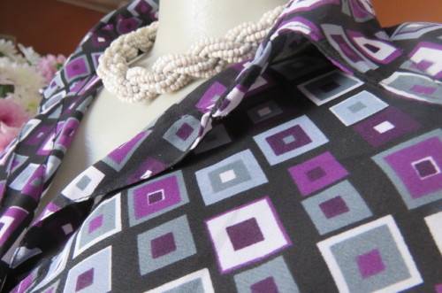 Elegant long sleeve top in black with off line purple, white and grey square blocks. Size 42/18