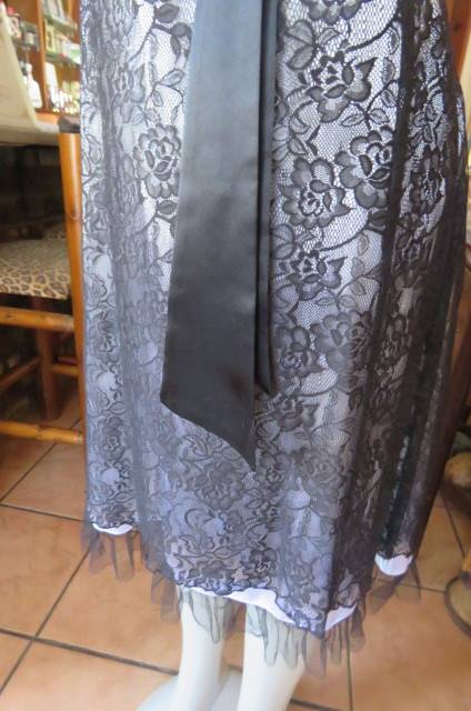 Smart black dress by `Donna Claire` in size 42/18. Cross over bust with ties.Satin top.