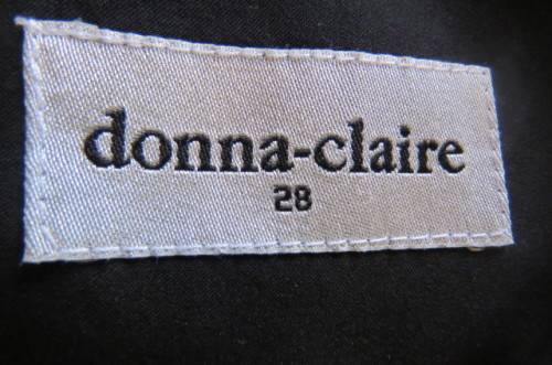 Smart black dress by `Donna Claire` in size 42/18. Cross over bust with ties.Satin top.