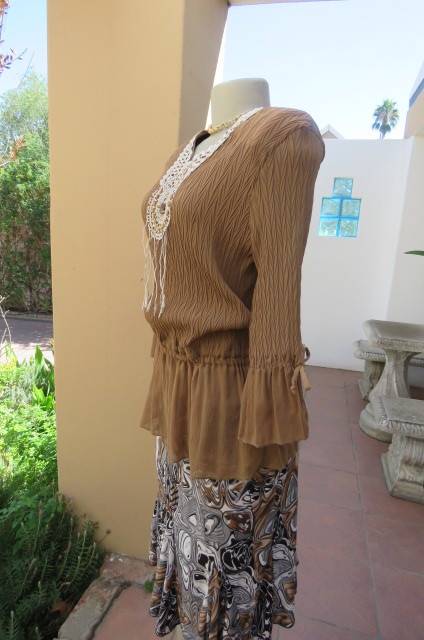 Fab light brown peplum style top in pattern creased 100% wash and wear polyester fabric.Size 36/12