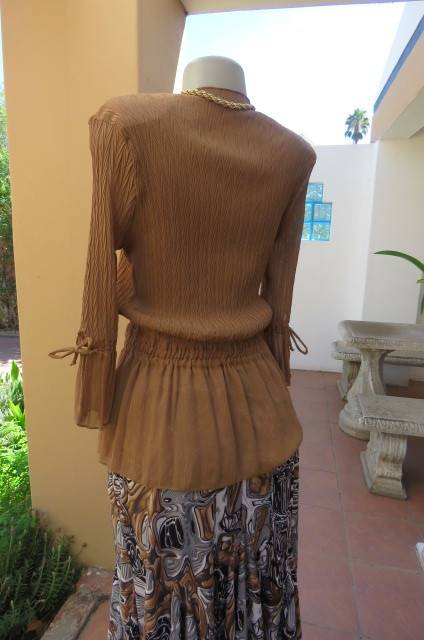 Fab light brown peplum style top in pattern creased 100% wash and wear polyester fabric.Size 36/12