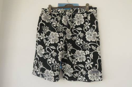 Men's black,white and grey floral TAMARAMA surf shorts in size Large. In 100% polyester fabric.