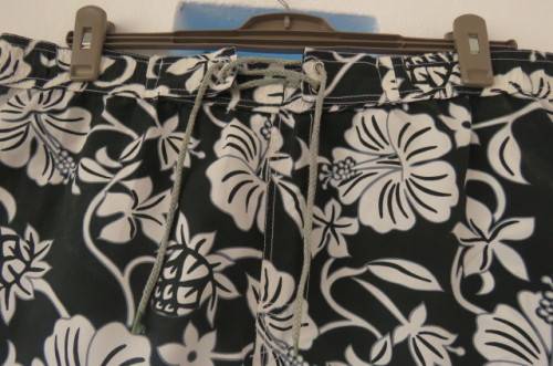 Men's black,white and grey floral TAMARAMA surf shorts in size Large. In 100% polyester fabric.