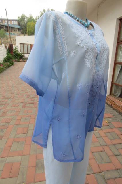 Embellished short sleeve top in different blue colours. Size 40/16. In sheer polyester. As new