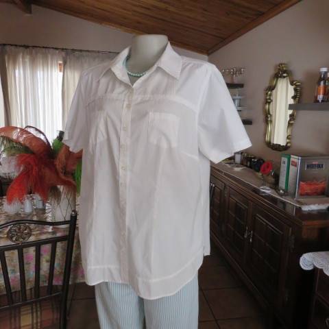 White as new short sleeve 100% cotton ladies shirt. Yoked with tucked decoration. Size 40/16.