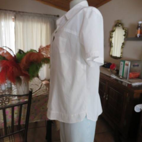 White as new short sleeve 100% cotton ladies shirt. Yoked with tucked decoration. Size 40/16.