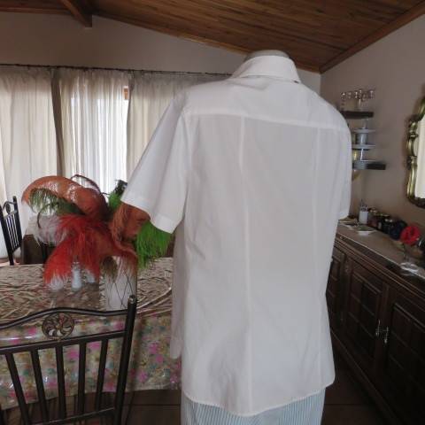 White as new short sleeve 100% cotton ladies shirt. Yoked with tucked decoration. Size 40/16.