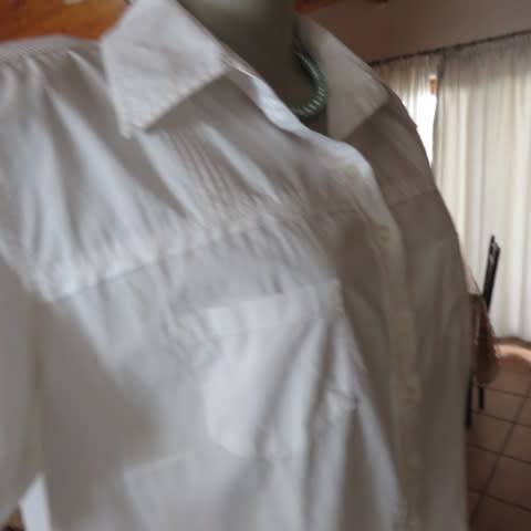 White as new short sleeve 100% cotton ladies shirt. Yoked with tucked decoration. Size 40/16.