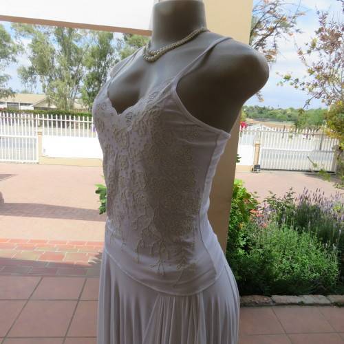 Embellished slip it over strappy top. For evening or day wear. Size 32 to 34. New condition.