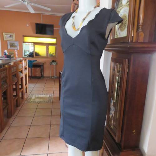 Fabulous sleek black dress with wide scalloped neckline. By `Massumi`. Size 34/10. Never used. New.