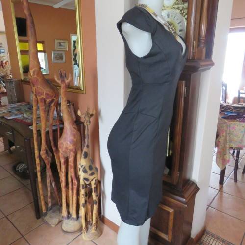 Fabulous sleek black dress with wide scalloped neckline. By `Massumi`. Size 34/10. Never used. New.