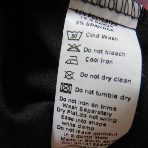 Fabulous sleek black dress with wide scalloped neckline. By `Massumi`. Size 34/10. Never used. New.