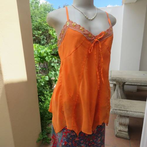 Lovely bright orange top. Thin adjustable straps. Pointed hemline. Size 36/12 by ` Shenga`. As new.