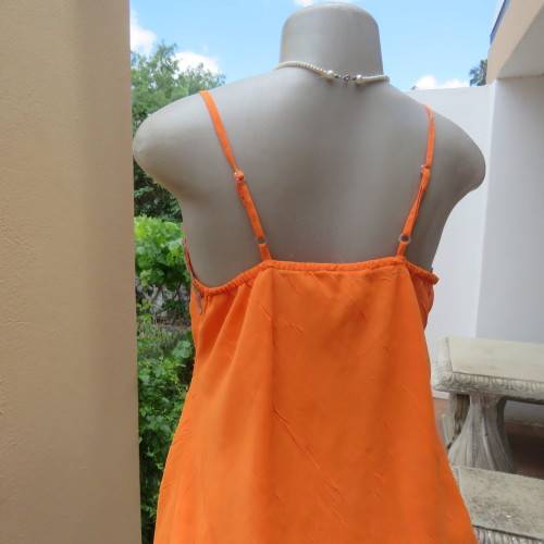 Lovely bright orange top. Thin adjustable straps. Pointed hemline. Size 36/12 by ` Shenga`. As new.