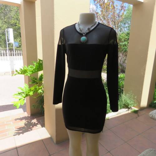 Cute little black bodycon dress with long sleeves in mini length. Size 32/8 by RT. New condition