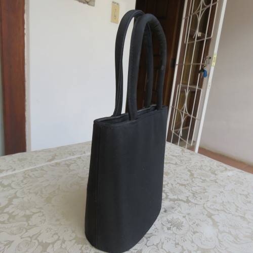 Small black bucket style handbag in shiny blocked vinyl .Size 18 x 16cm. As new