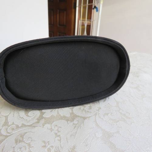 Small black bucket style handbag in shiny blocked vinyl .Size 18 x 16cm. As new