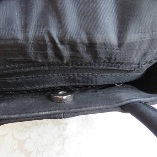 Small black bucket style handbag in shiny blocked vinyl .Size 18 x 16cm. As new