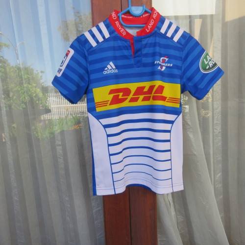 ADIDAS Stomers short sleeve top in blue, white and red. For boy 11 to 12 year old boy. New.