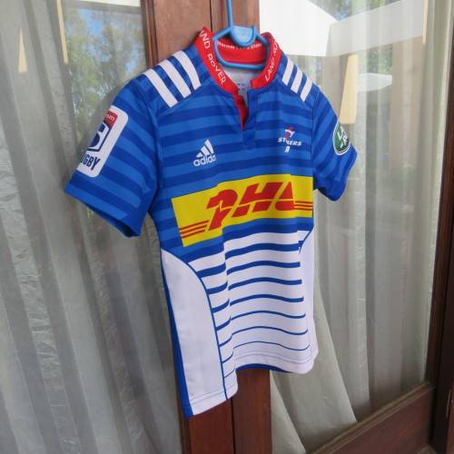 ADIDAS Stomers short sleeve top in blue, white and red. For boy 11 to 12 year old boy. New.