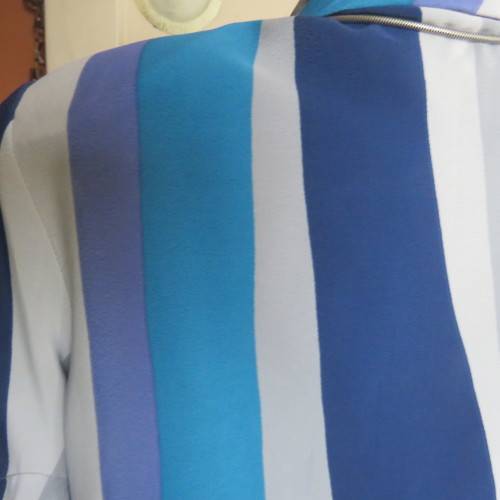 Pretty graphic patterned short sleeve top in blue,greys and lavender polyester. Size 36/12. As new
