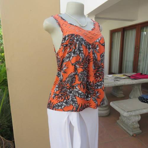 Cute colourful sleeveless top in orange with black/white leaves.Orange lace front decoration Size 36