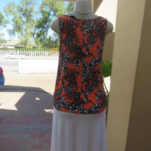 Cute colourful sleeveless top in orange with black/white leaves.Orange lace front decoration Size 36
