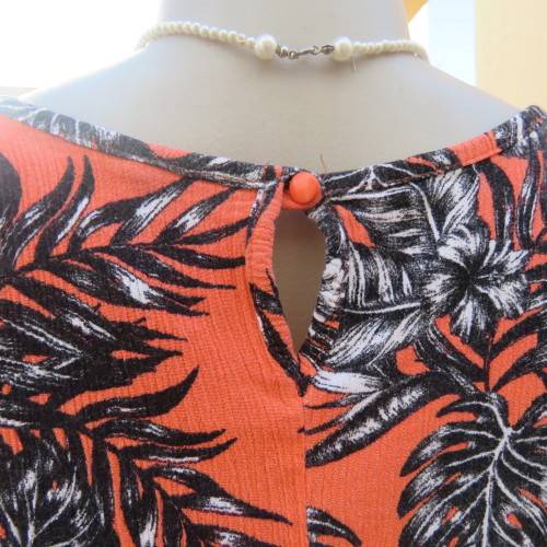 Cute colourful sleeveless top in orange with black/white leaves.Orange lace front decoration Size 36