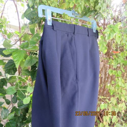 Smart navy Men`s pants by SIGNATURE in size 30. Pleats on front. Turnups on legs. New condition.