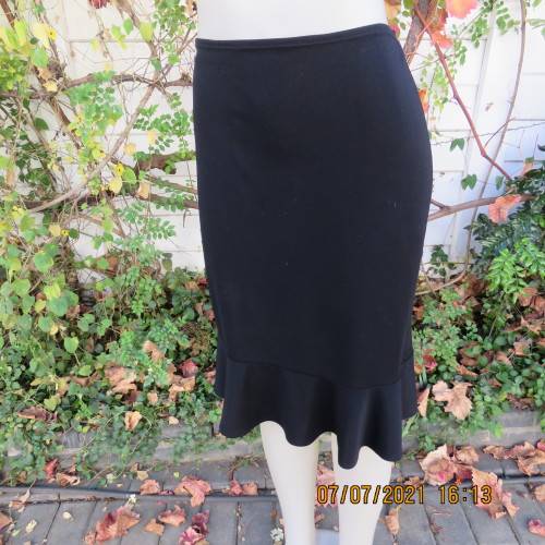 Wear anywhere black pencil skirt with flare cut seam frill.In 100% stretch polyester.Size 36/12