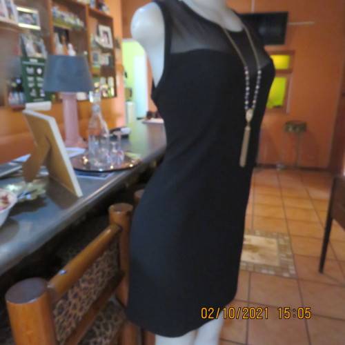 Little black dress ! Sleeveless with round neckline. See-through neck area. Size 40/16. By IQ.