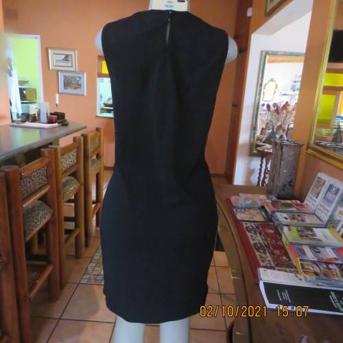 Little black dress ! Sleeveless with round neckline. See-through neck area. Size 40/16. By IQ.