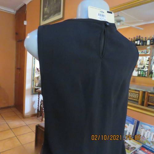 Little black dress ! Sleeveless with round neckline. See-through neck area. Size 40/16. By IQ.