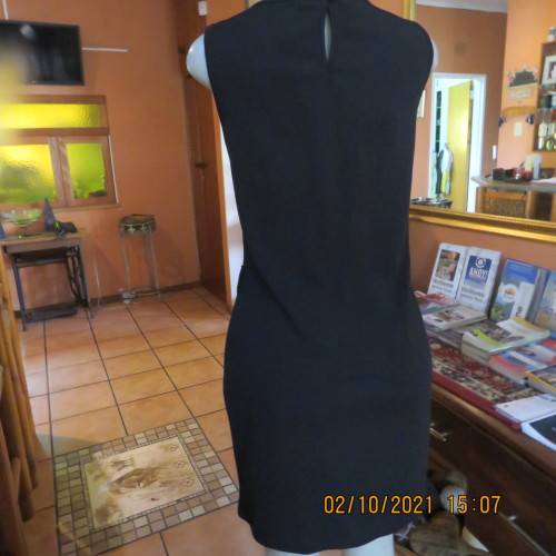 Little black dress ! Sleeveless with round neckline. See-through neck area. Size 40/16. By IQ.