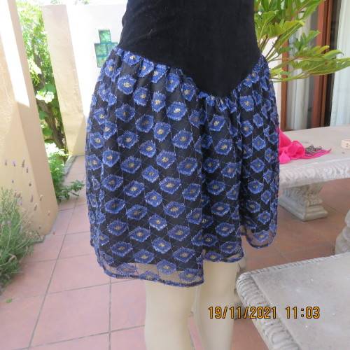 Youthful black velvet dropped waist dress. Acrylic lace,blue,gold skirt and shoulders.Size32 byOTT