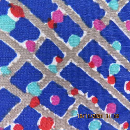 New blue patternened slip over stretch polyester top. Short front zip and embellished collar.Size 36