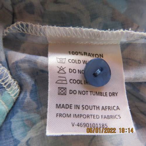 Exquisite 100% rayon CUPID short sleeve top in medley of blues and turquoise.Button down.New cond.