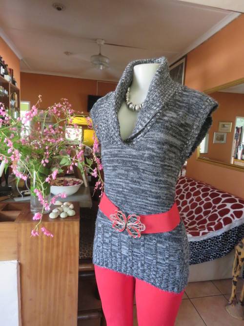 Stylish black/white mottled long acrylic knit sleeveless top.Foldover fireside collar.Size 36/12.