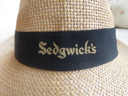 Men`s paper rattan fedora style hat size 58cm. Black band with SEDGWICK`S logo.New condition