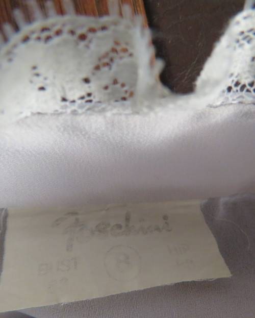 Stylish 80`s long sleeve button down light grey blouse with high banded collar.Size 32 by FOSHINI.