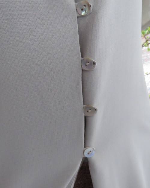 Elegant oyster beige short sleeve polyester top with open collar.Close with buttons/loops.Size 36