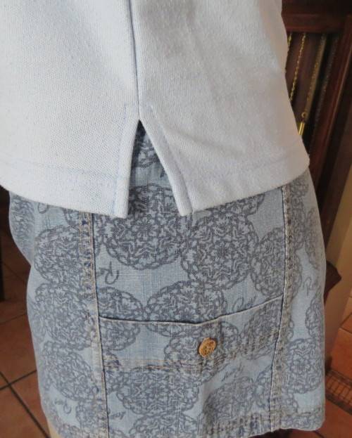 LACOSTE light blue top with white knitted collar and edging.Size 34 to 36.Opening in front.Good cond