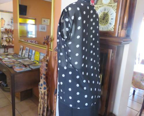 Sheer black and white polkadot button down top with tiny cut on sleeves. Size 34/10.As new cond.